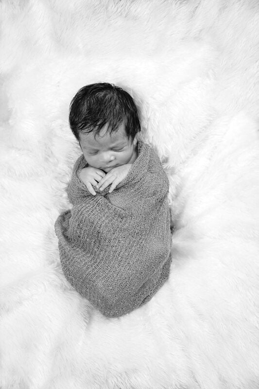 A baby wrapped in soft muslin