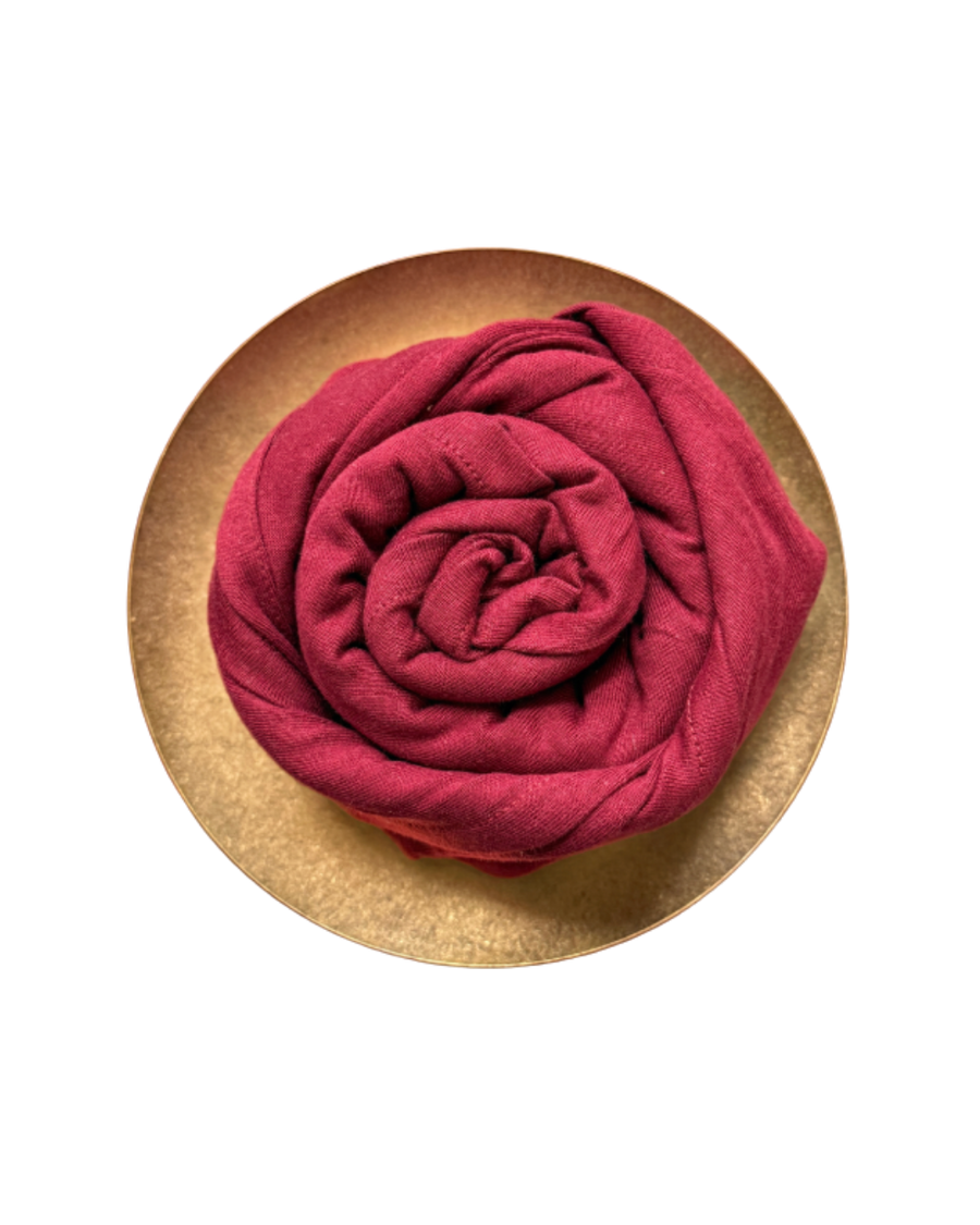 Red cotton muslin rose on a gold plate