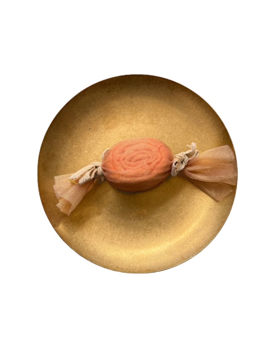 Peach candy-style muslin fold on a gold plate
