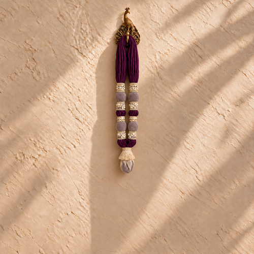 The Mini Maala by White Flowerr, purple cotton muslin towel garland with gold and pearl trims on a gold peacock hook