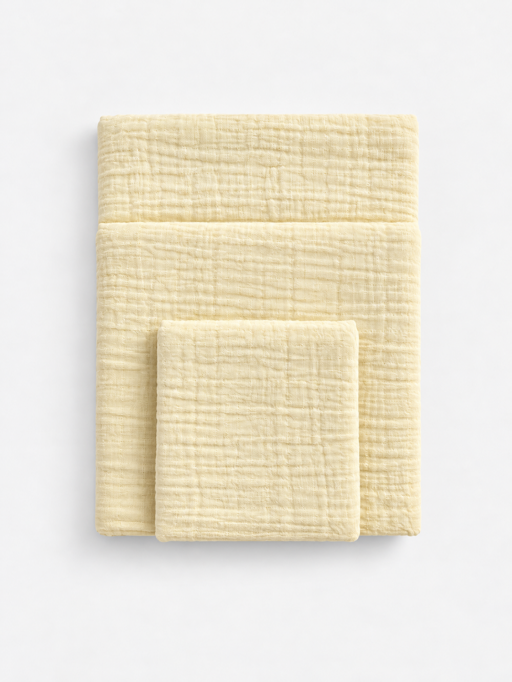Butter Cream cotton muslin towel colour reference by White Flowerr, showing folded towels in different sizes