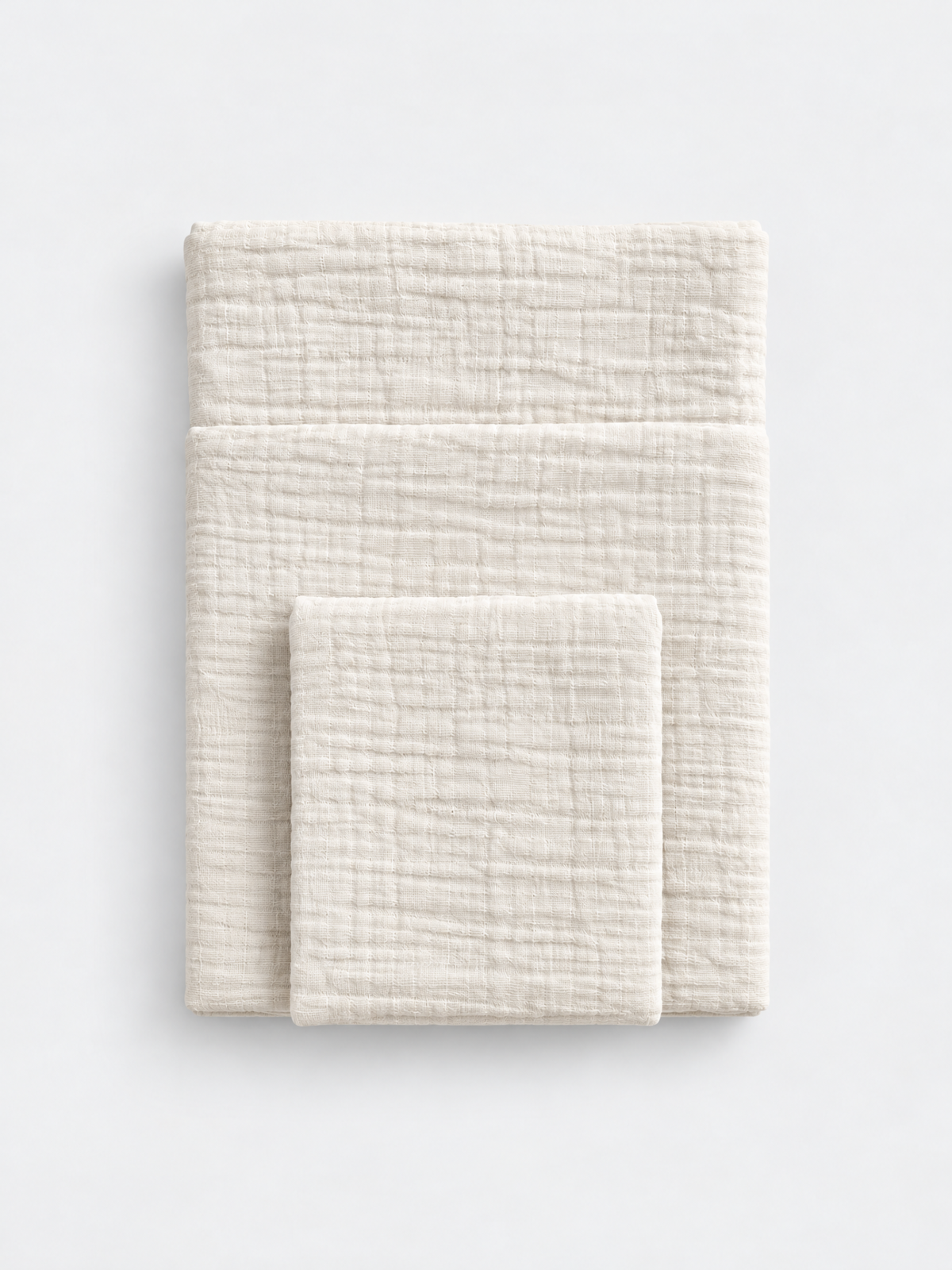 French Vanilla cotton muslin towel colour reference by White Flowerr, showing folded towels in different sizes